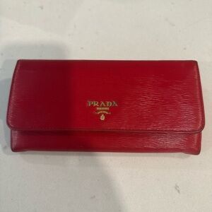 Prada red envelope leather wallet automatic.